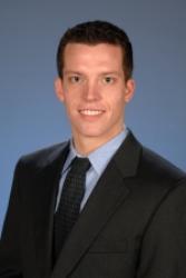 Headshot of Kevin Nead in a suit jacket and tie