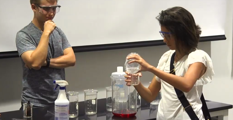 A student mixes liquids as part of an HP-Camp experience